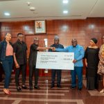 Kwabena Boateng, Deputy Managing Director, Fidelity Bank, handing over the cheque to Chief of Staff Hon. Julius Debrah